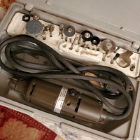 Dremel Moto Tool rotary tool with cord and accessory bits in styrofoam insert inside carrying case