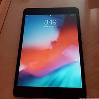 iPad screen powered on showing home screen bright and clear, device in good cosmetic condition