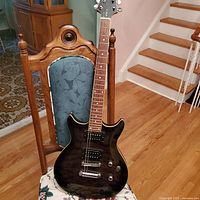 Front view of guitar on chair showing body and neck alignment