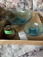 Set of three blue glass items in cardboard box, one marked signed with green tape.