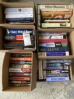 Top view of four boxes filled with hardcover and paperback books