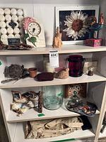 White votive candles, pink clock, sunflower print, Jim Shore rooster, wooden carving, red glass candle holder, bird figurines, glass domes, terrarium jar