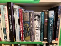 Shelf of assorted books showing titles and condition