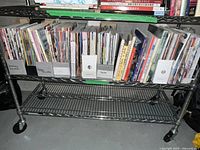 Shelf with multiple craft books and magazines lined up side by side showing various colorful spines.