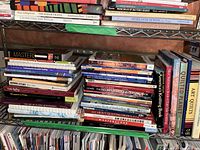 Bookshelves filled with crafting and quilting books, showing titles and spines of various books on quilting techniques and art quilting.
