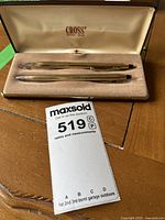 Cross brand pen and pencil set displayed side by side in their original protective case, showing the full set