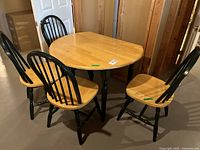 Full view of table with four chairs showing overall set configuration