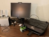 Photo showing Lenovo monitor, HP printer, HP ink cartridges, and Dell speakers