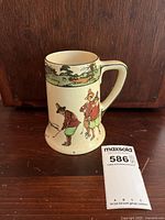 Front view showing a golfer putting with two observers on crazed cream glaze surface