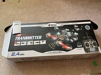 Box showing WLtoys V222 3D Micro Transmitter drone with 2.4 GHz frequency, 4 channel control, and model number.