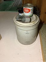 Front and side view of the Medalta 3 gallon stoneware crock showing size and branding.