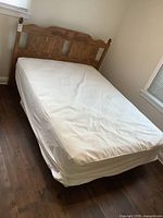 Full view of the vintage double bed fully assembled with mattress and covers