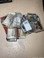 Pile of hockey cards in plastic cases and pouches, viewed from above on a light surface.