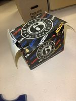 Photo showing closed Original 6 hockey cards box on table with 'Original 6 Hockey Cards' and team names printed on box sides.