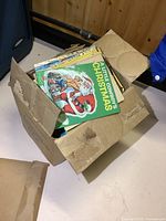Cardboard box full of vintage kids books showing wear and age