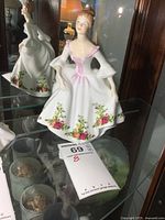 Full front and side view of the Royal Doulton Country Rose figurine showing the floral details and dress design.