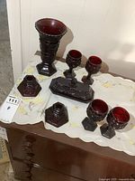 Photo showing entire set including vase, goblets, candle holders, and butter dish on table