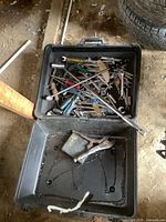 Top view of open plastic case filled with assorted wrenches, screwdrivers, breaker bar, and socket wrenches.