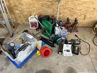 Full view of all contents including ATV winch, battery, oil containers, jack stands, funnels, and tools.