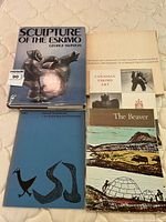 Five books on Indigenous Eskimo art - covers visible with titles and artwork shown.