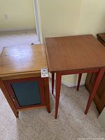 Music stand and small table side by side from front view, showing relative size and condition