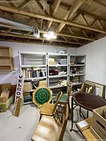Wide view of three shelving units along a basement wall with five shelves each, showing minor wear. Various stored items present but not included in lot.