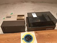 Strato 800 slide projector and Soundesign turntable shown together with a 45 RPM record.