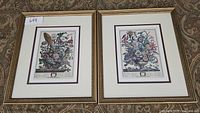 Two framed floral prints together showing complete lot. Prints are double matted in gold frames measuring approximately 13 x 15 inches.