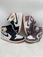 Two pairs of Air Jordan sneakers side by side on a white background