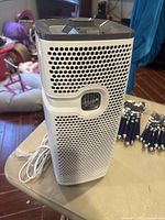 Holmes AER 1 air purifier showing front and vent design on a table