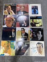 Top view of 12 Frank Sinatra vinyl LP albums arranged in a grid. Covers feature portraits and artwork of Frank Sinatra.