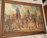 Framed impressionistic cityscape canvas art titled Sunday Afternoon by Jack Laycox with visible texture and wooden frame, measuring about 21 x 26.5 inches.