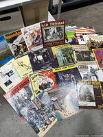 20 jazz and ragtime vinyl record albums laid out on a table showing covers with various artists and designs