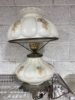 Full view of the large Gone with the Wind hurricane lamp showing frosted glass with painted floral decor and metal base.