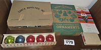 Overview of multiple vintage ornament boxes showing grouped ornaments inside.