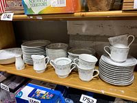 Partial set of Royal Gallery Suzanne pattern fine china including cups, saucers, creamers, plates, and sugar bowl.