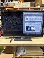 Front view of the Sharp Aquos LC52LE810UN 52-inch TV powered on, showing network setup screen.