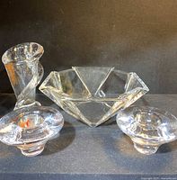 Group photo showing all four glass items: two votive candle holders, twisted vase, geometric bowl.