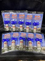 Photo showing ten new Frontiersman Bear Horns in original packaging, arranged in two rows on a black background.