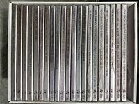 Photo showing the 38 boxed sets arranged upright in a tray, each labeled with names of famous big band artists such as Glenn Miller, Duke Ellington, Benny Goodman, and Count Basie.