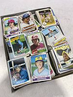 Photo showing box top with various baseball cards laid out, featuring multiple players from Phillies, Brewers, Royals and others.