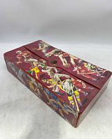 Closed red sports card holder with colorful illustrations of various athletes including football and baseball players on the exterior.