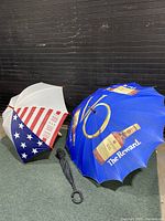 Photo of large vintage umbrellas showing American flag design and Seagram's VO Whiskey advertisements