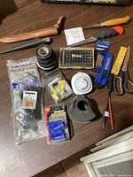 Overview of assortments including file, multi-bit set, probe leads, scissors, connectors, cable ties, utility tool, and timer.