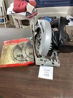 Black & Decker circular saw on table with boxed Nicholson spare blades.