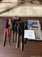 All screwdrivers and bit set along with tape measure arranged on table showing condition and branding.