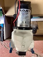 Flojet R3526-144 water system pump showing model and specifications label.