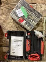 Jobmate rotary tool and accessory kit in a black hard carrying case with instruction manual and assorted bits in plastic box.