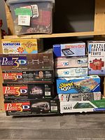 Photo of stacked Wrebbit 3D puzzle boxes, Smart Puzzle Sort & Store tray on top, showing puzzle models and piece counts.