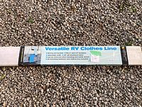 Photo showing the full packaged RV clothes line with label detailing product specifications and features.